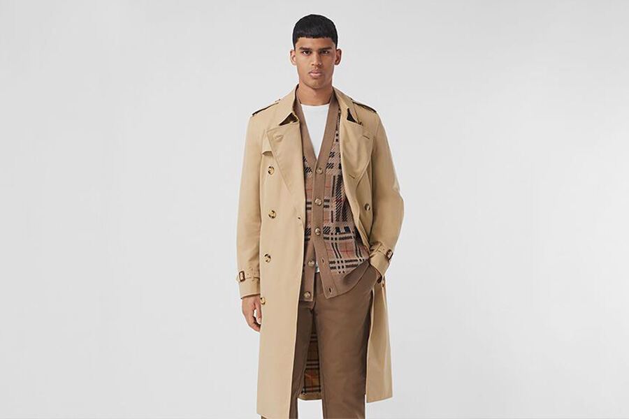 A man wearing a trench coat with an inner vest