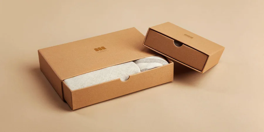 small and large flat cardboard boxes with clothing inside