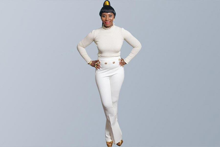 Woman wearing white long sleeve top over white pants