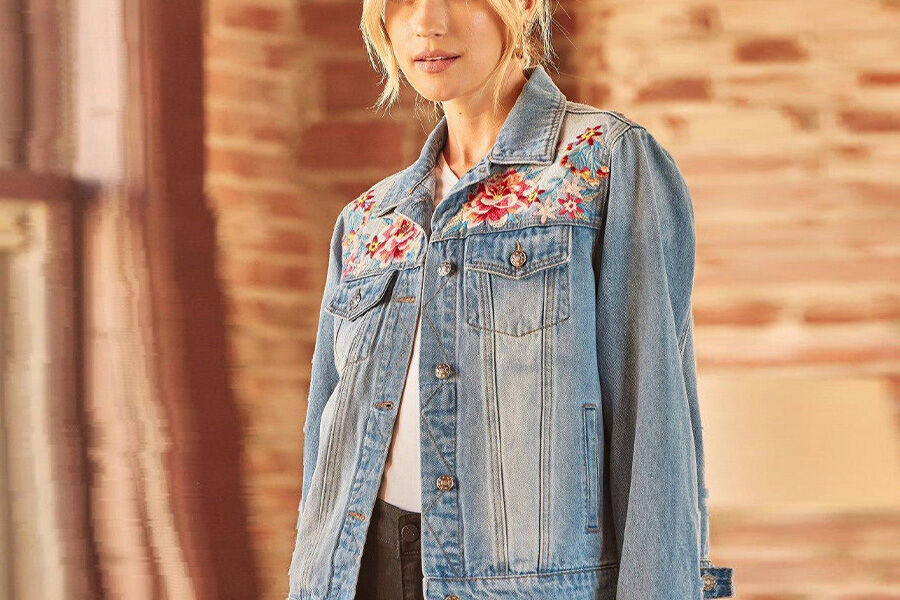 Blonde wearing a denim jacket with flower embroidery