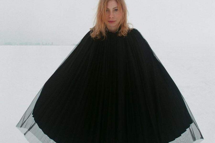 Lady wearing a black silk-layered poncho
