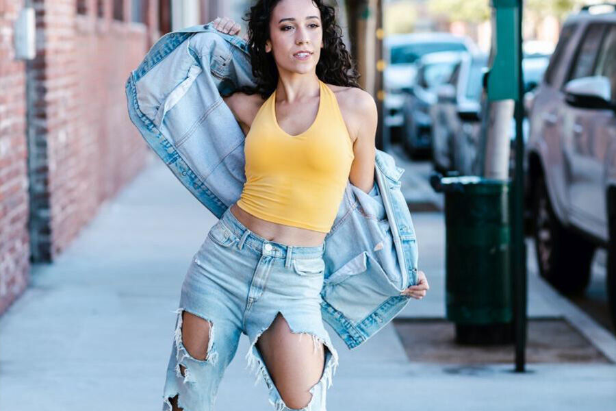 Lady wearing a denim jacket with distressed pants