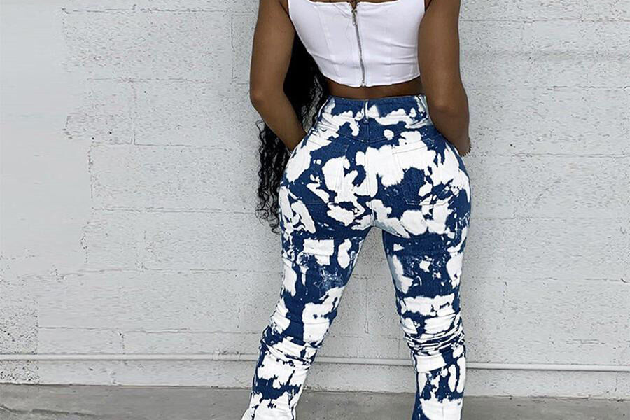 Woman wearing a white crop top with digital-print denim