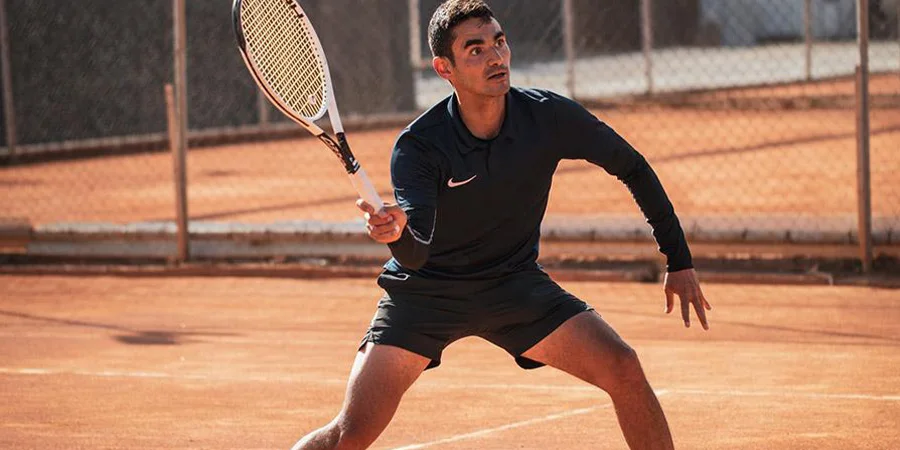 Man playing tennis with a blue T-shirt