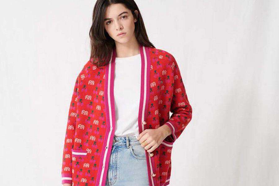 Young lady wearing a pinkish-red jacquard cardigan