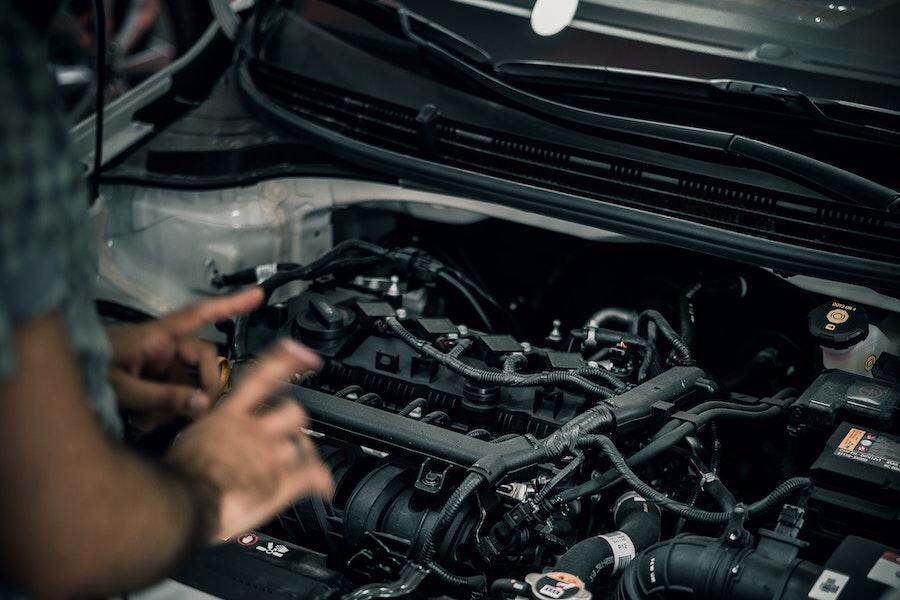 Man diagnosing a car engine