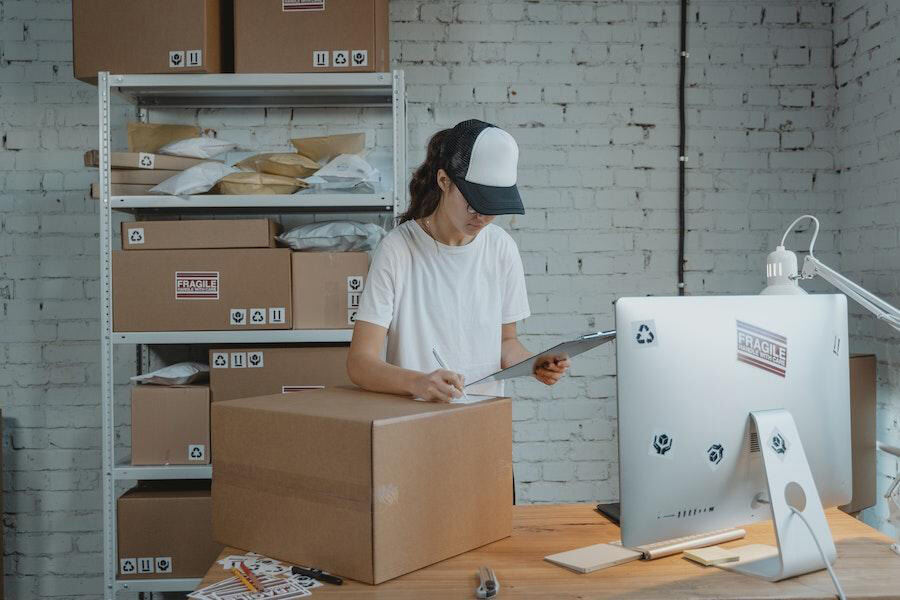 Woman inspecting goods in boxes