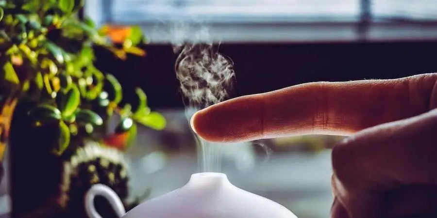 Finger on steam coming from an aroma diffuser