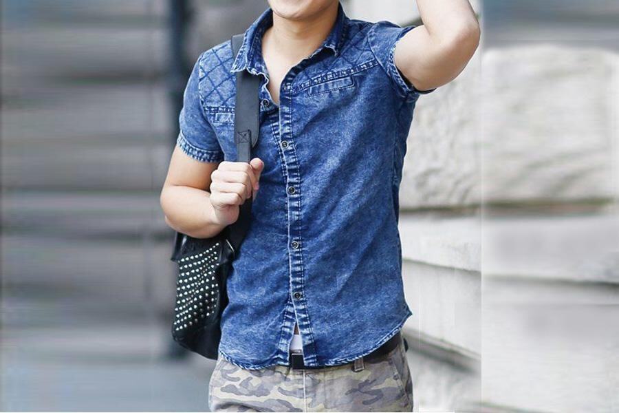 Man posing in a denim shirt