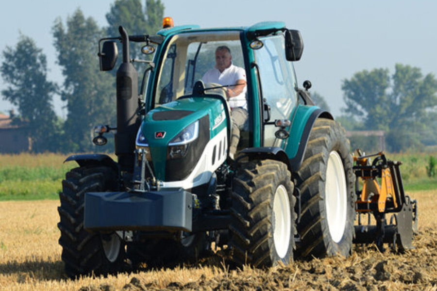 a tractor hard at work tilling soil