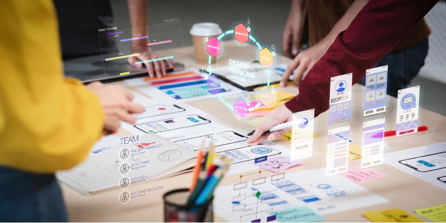 ux developers and ui designers use augmented reality to brainstorm about mobile application interface wireframe design for the modern office desk.