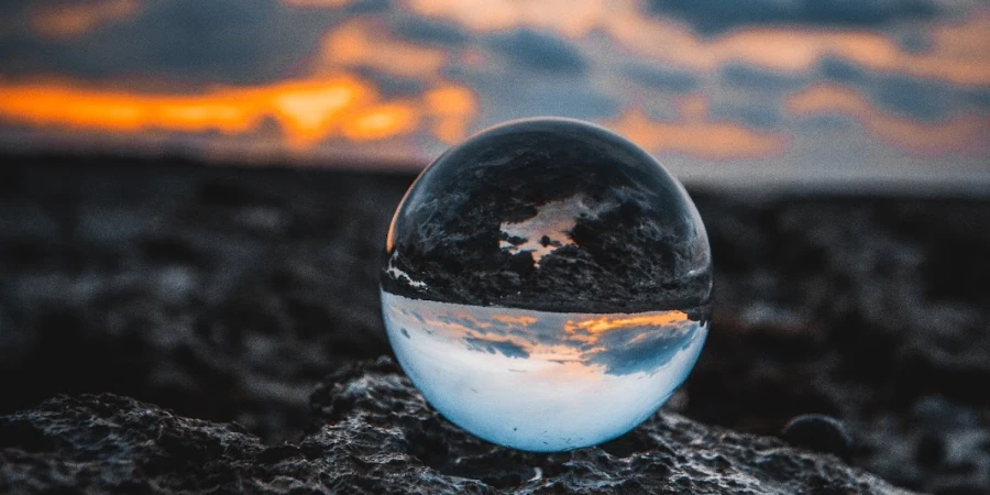 droplet showing reflection of earth and sky