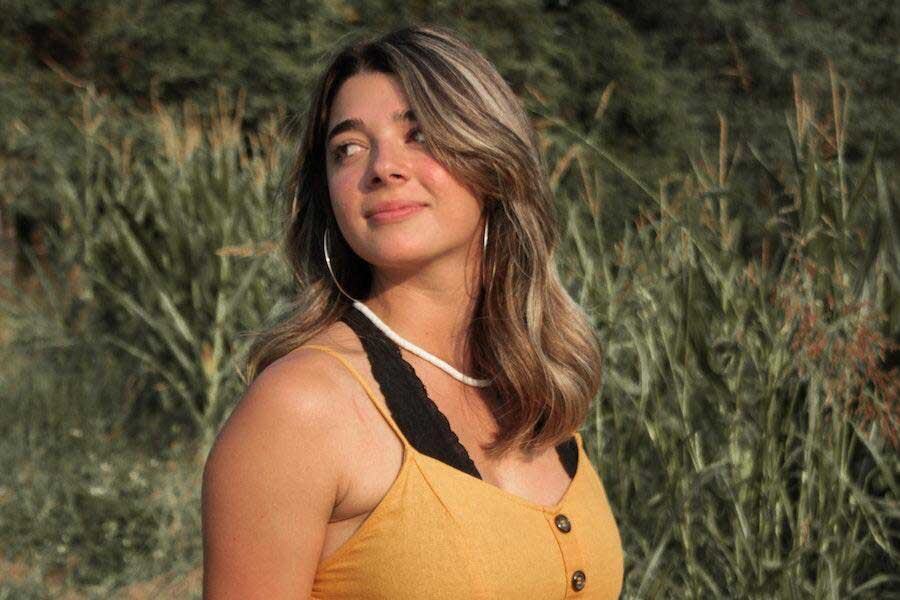Woman looking sideways while rocking an orange outfit