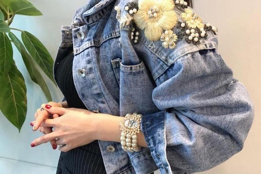 Woman in embroidery denim jacket Woman wearing an embroidery denim jacket