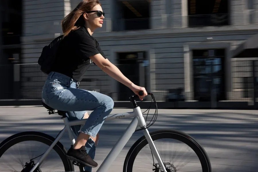 A woman on electric bicycle riding on the road