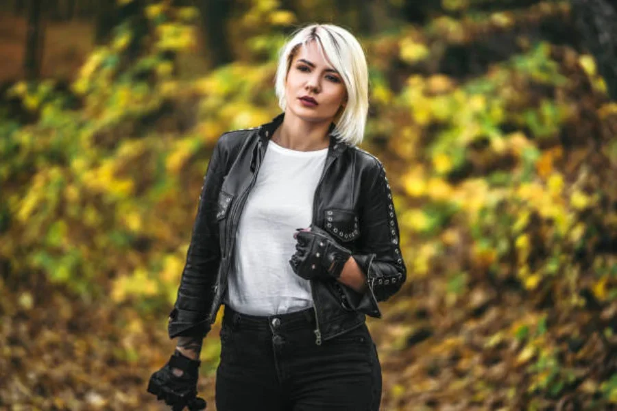 A woman wearing black biker jacket and a white t-shirt