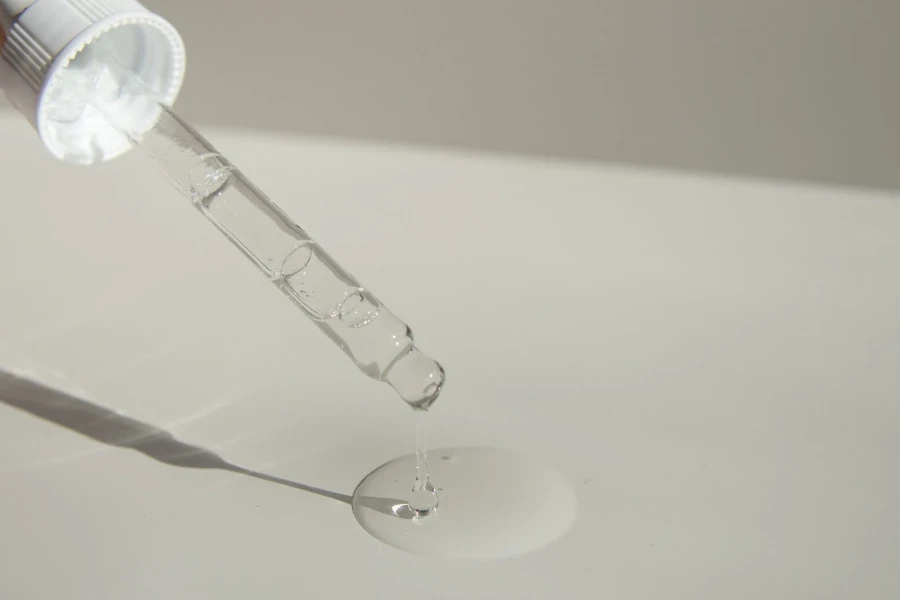 Perfume dripping from a clear glass pump