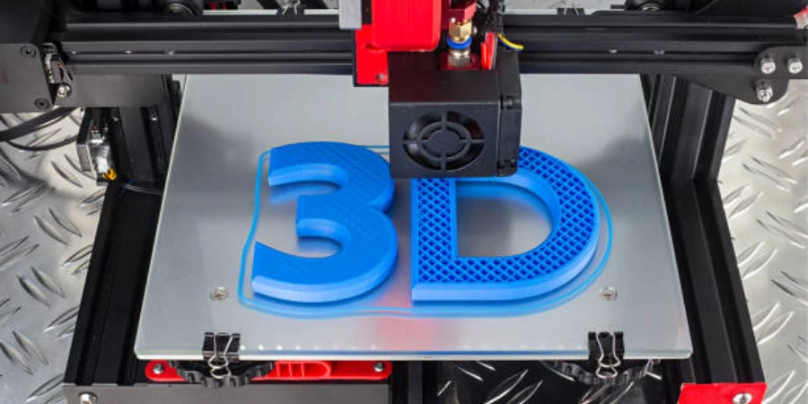 Red and black 3D printer printing a blue logo on a metal
