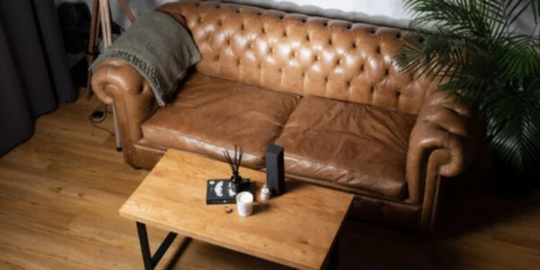 Two-seater leather Chesterfield sofa with a center table in front