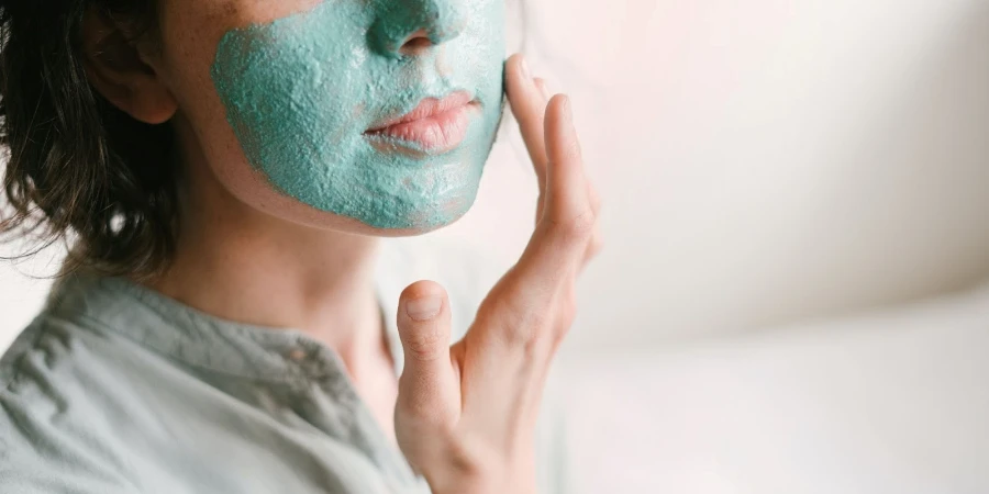 Woman applying a beauty face mask