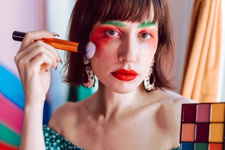 Woman applying neon makeup