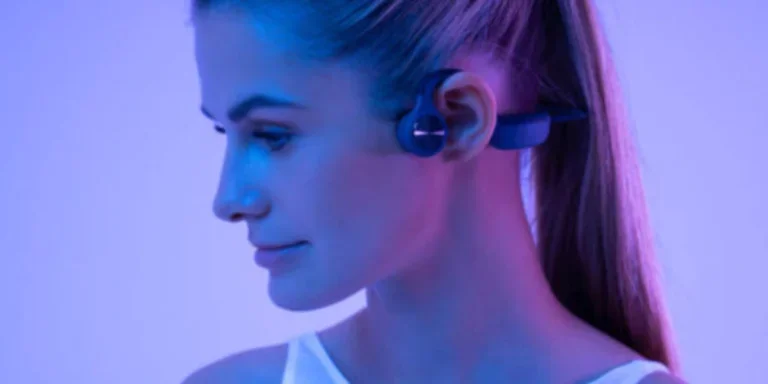 woman in white tank top wearing bone conduction headphones