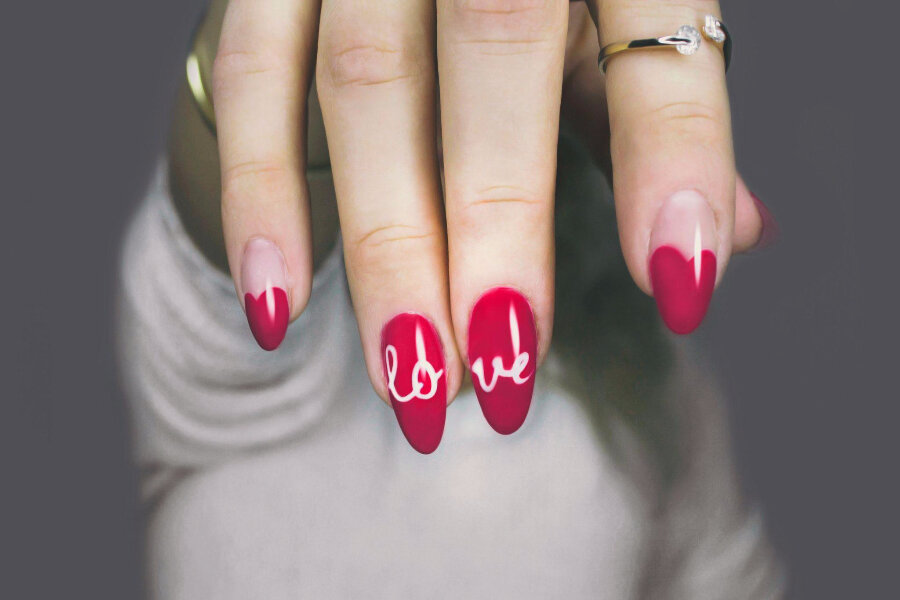 Woman with bold, pink, acrylic, almond-shaped nails