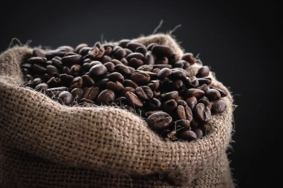close shot of calico sack full of coffee beans