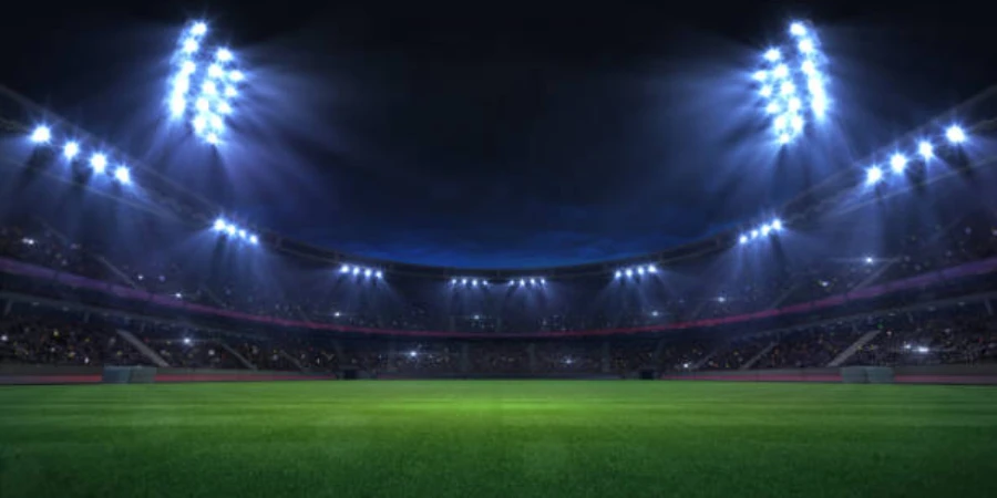 Large football stadium with tall stadium lights at night