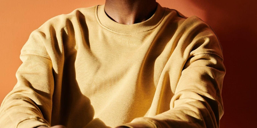 Man wearing a gold-colored long-sleeve tee