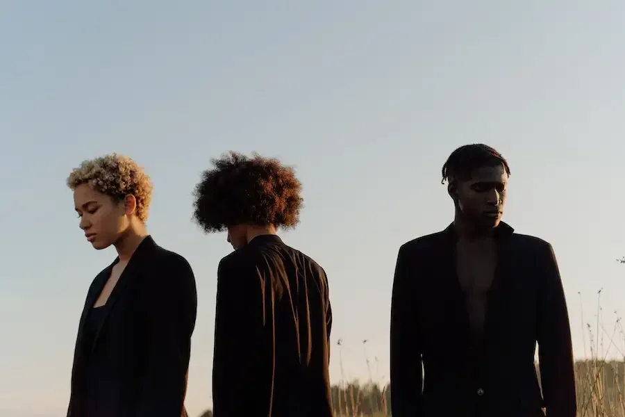 Multiple people wearing black outfits