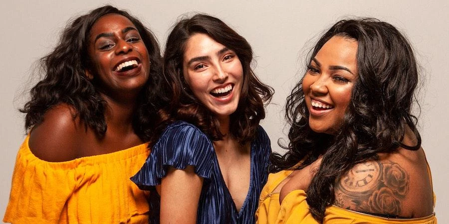 multiple women smiling in trendy apparel