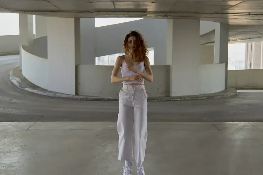 Redhaired lady posing in pair of baggy cropped trousers