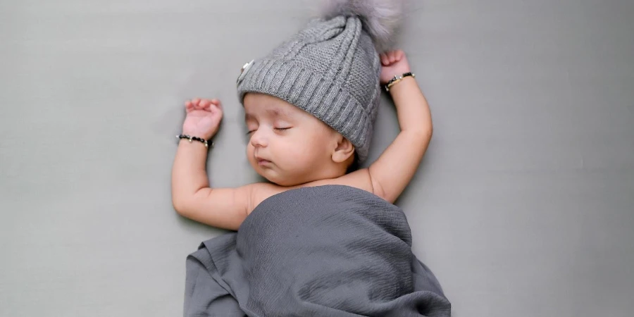 Sleeping baby wearing a pom pom beanie