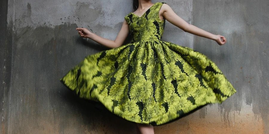 Woman posing in a beautiful green patterned dress