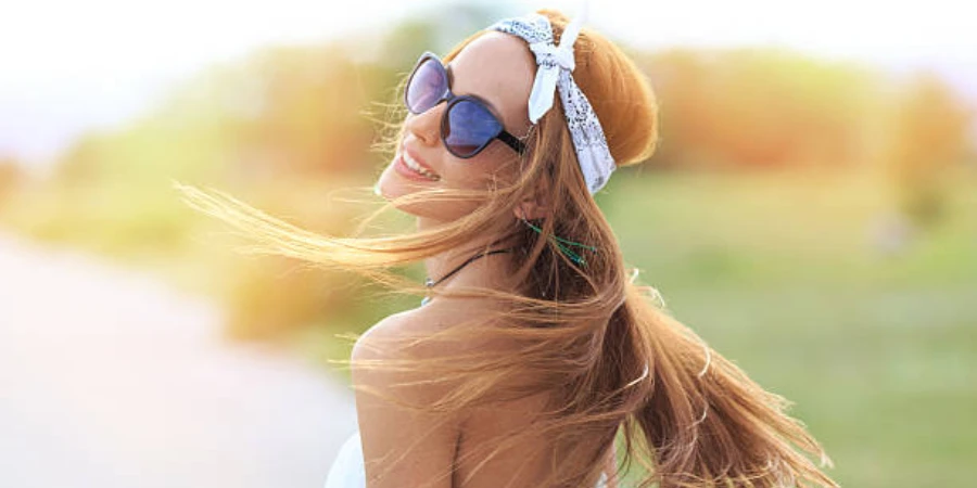 Woman twirling in the sunlight wearing a white headband