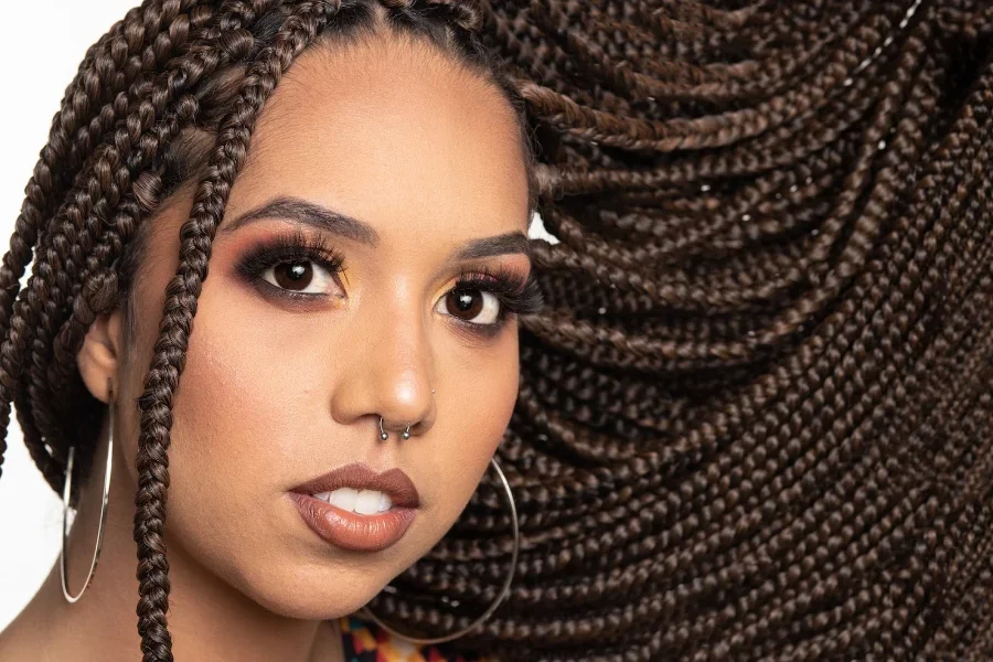 A close-up of a woman with long braided hair
