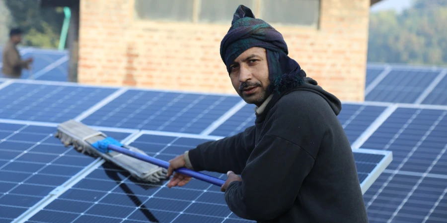 a man cleaning a solar panel