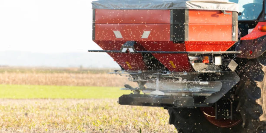A tractor spreading fertilizer in a field