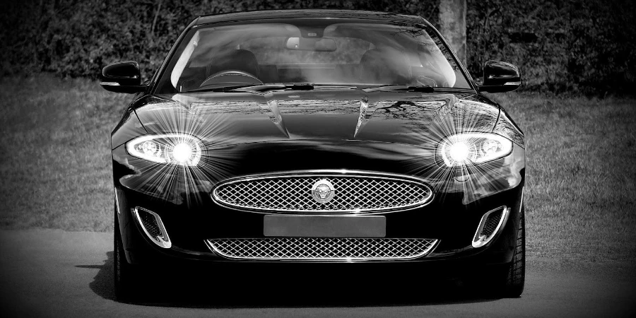 Black Jaguar with well-lit headlights
