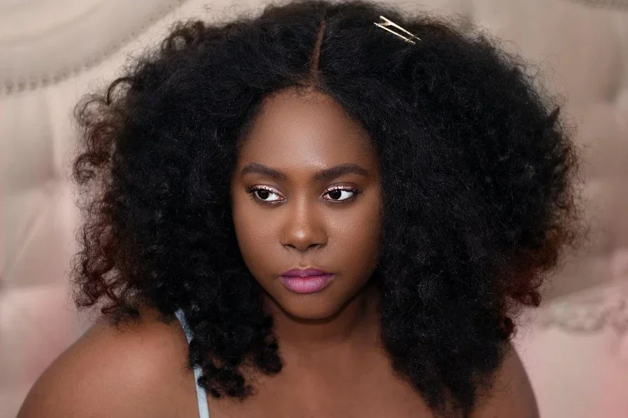 Curly-haired woman with small hair clip