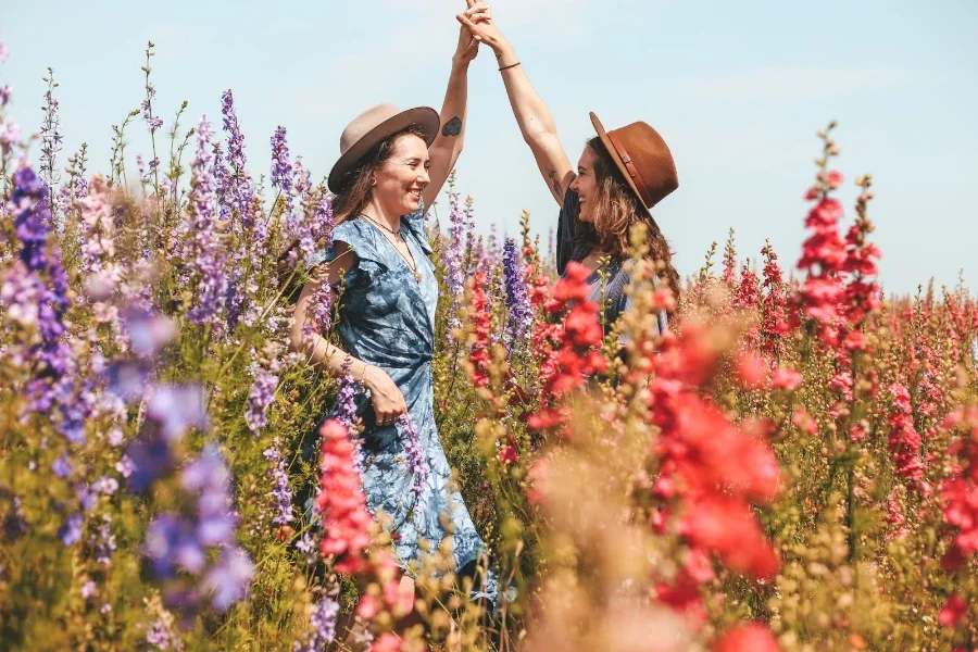 Two women dancing in a field of flowers