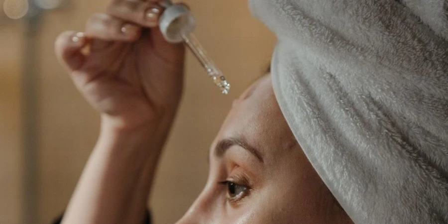 Woman applying skin finish on her forehead