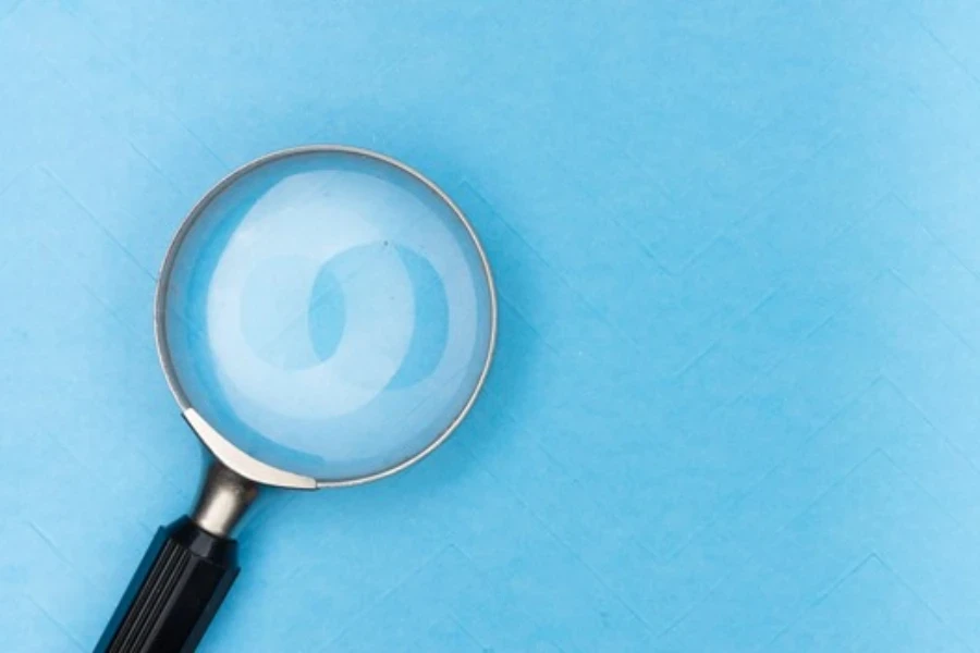 A magnifying glass on a blue table