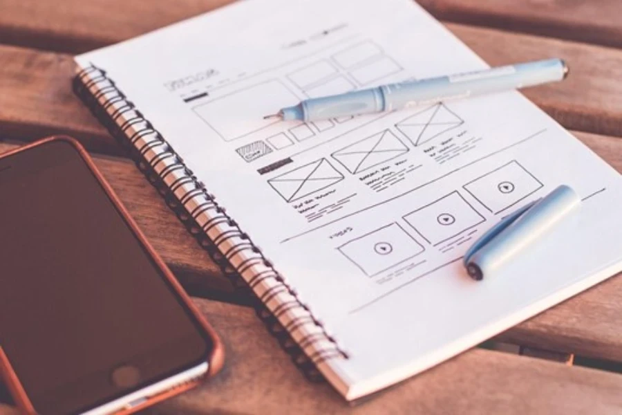 Notebook beside a smartphone on a table