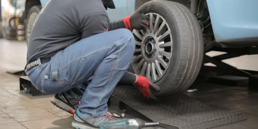 A car user fixing a flat tyre