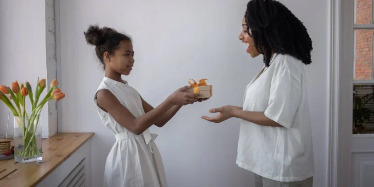 A girl giving her mom a present