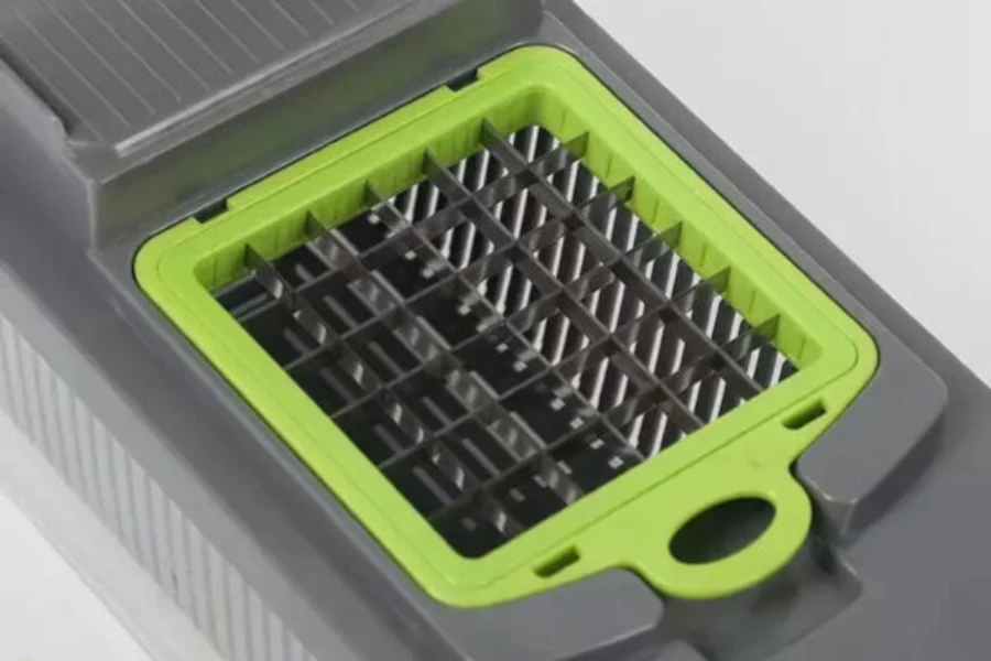 A gray and green 12-in-1 food dicer