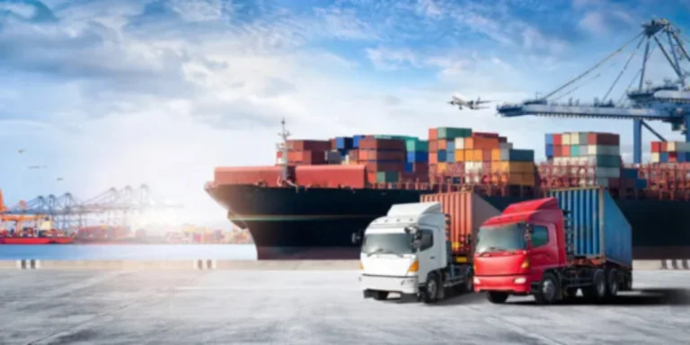 A ship with cargo containers together with two trucks