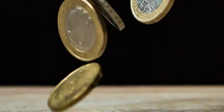 Coins on brown wood